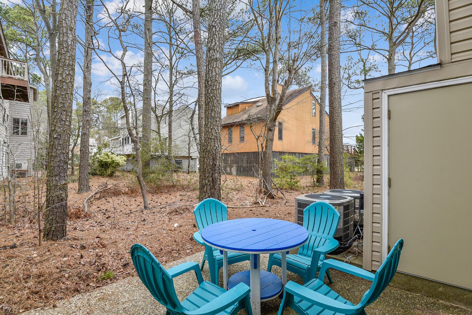 Enjoy morning coffee or evening gatherings at your private patio, framed by tall trees and a peaceful wooded setting that makes your retreat feel beautifully secluded.