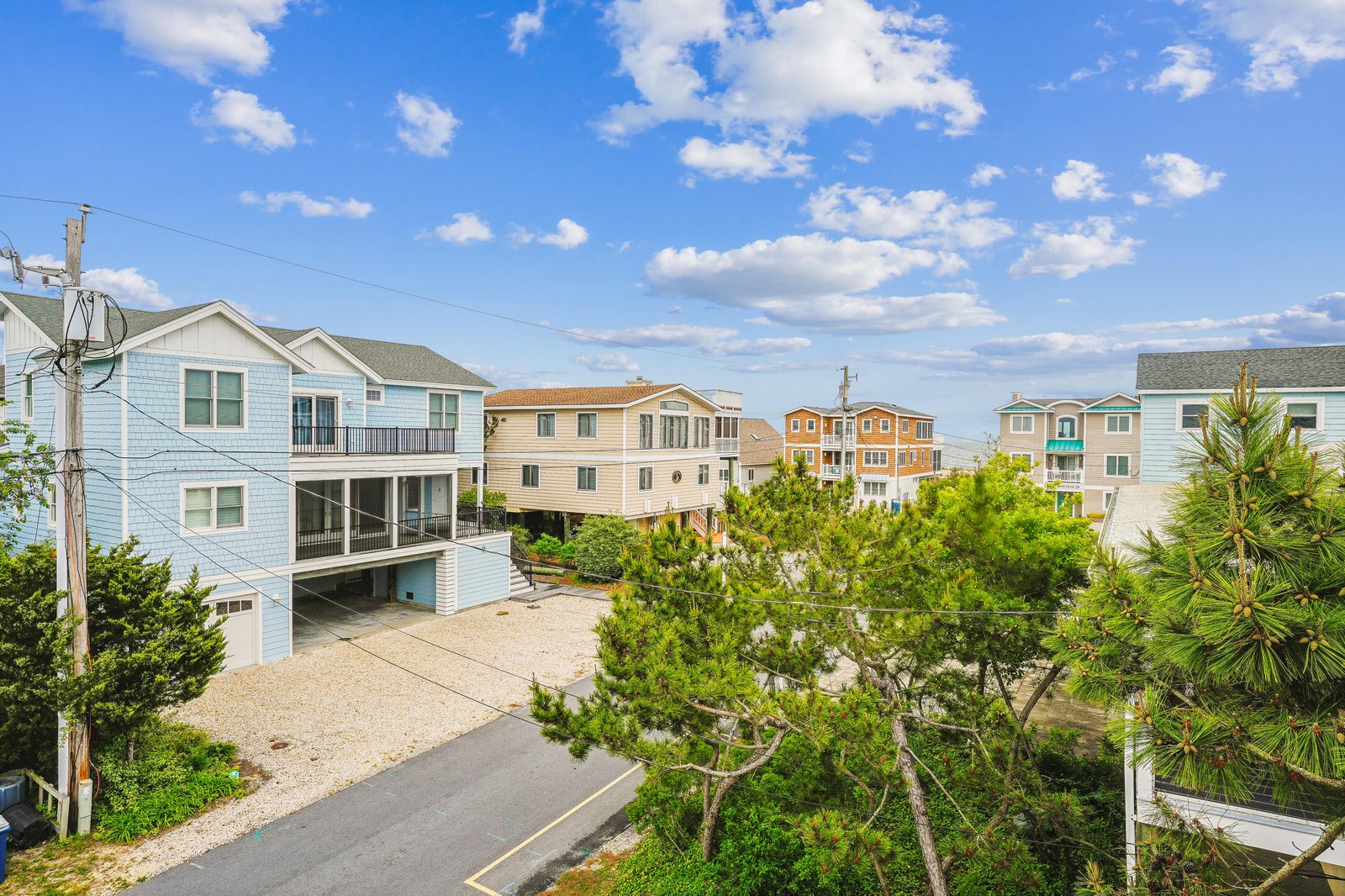 Property located in a charming coastal neighborhood with nearby beach access and scenic coastal surroundings under bright blue skies.