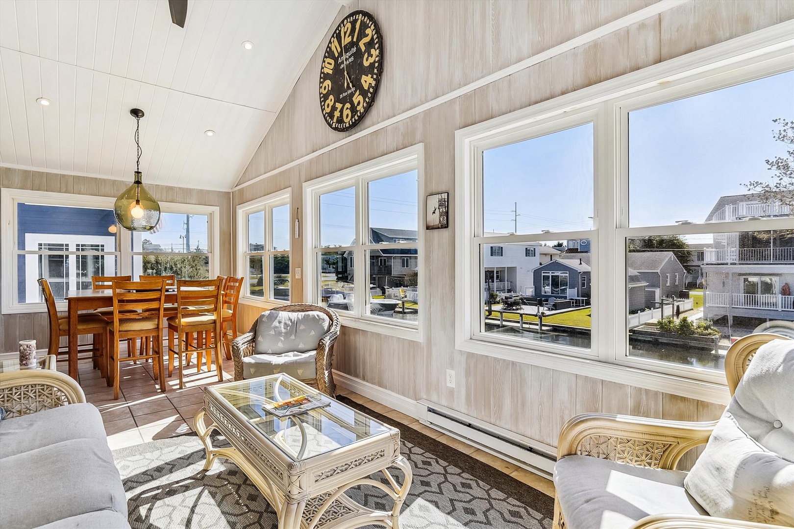 Relax in this sun-drenched living space with vaulted ceilings, cozy seating, and a dining area perfect for morning coffee or evening meals as natural light pours through large windows.