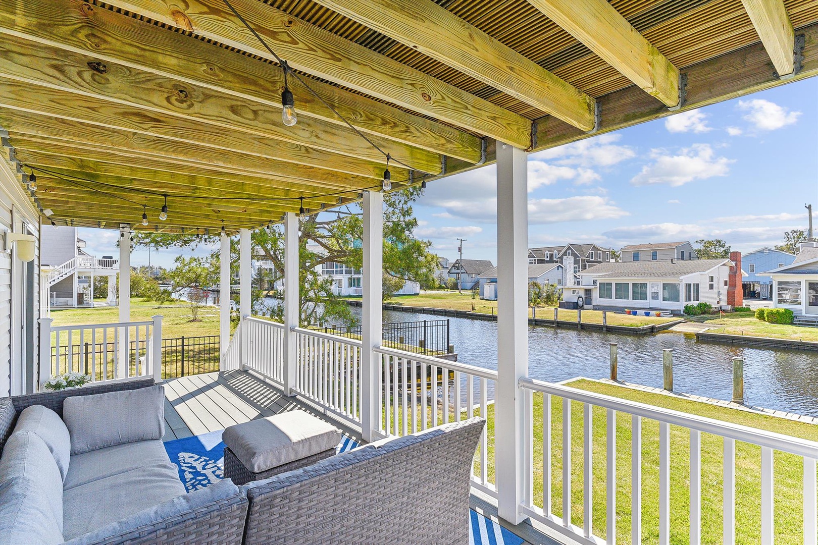 Relax on your covered patio overlooking the serene canal, perfect for morning coffee or watching the sunset reflect on the water.