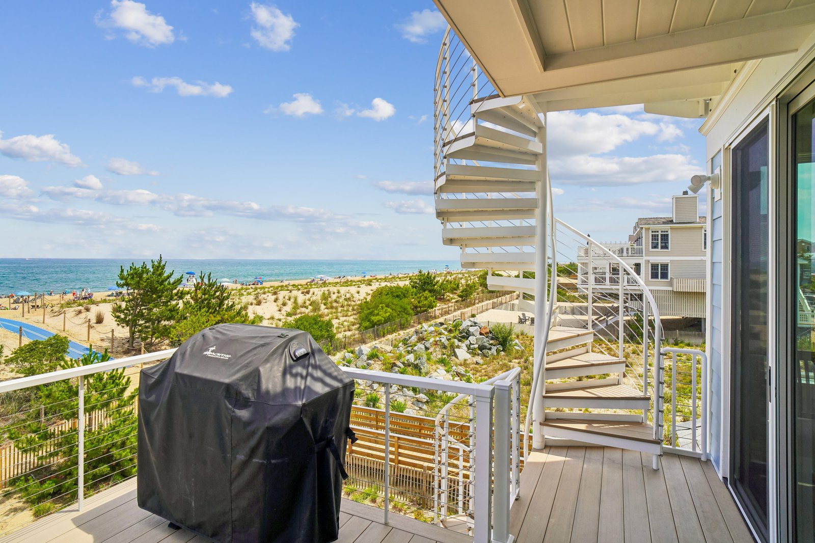 Your private deck opens to sparkling ocean and soft sand dunes—perfect for morning coffee, grilling, or simply soaking in the coastal breeze.