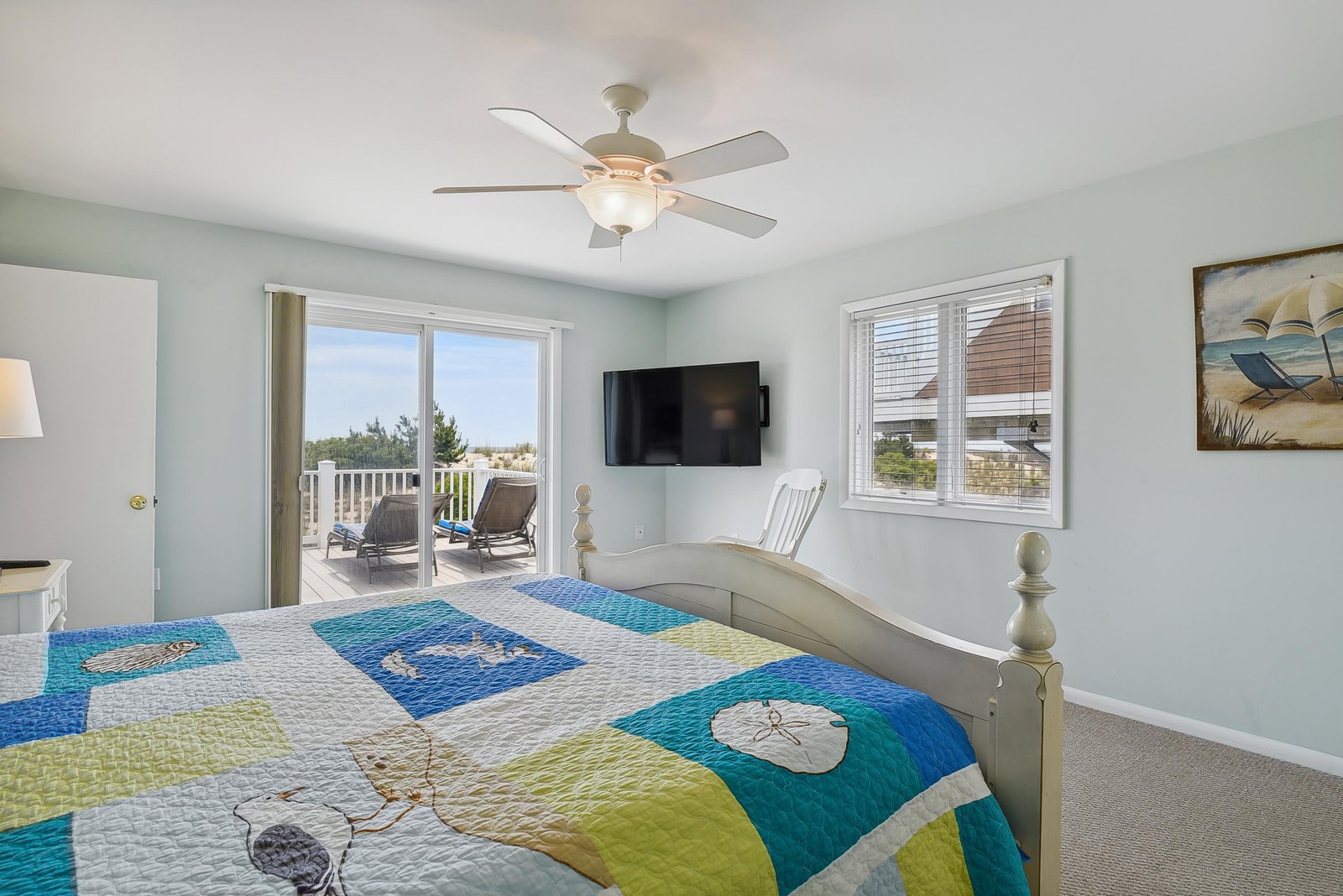 Wake up to soft coastal breezes and step out onto your private balcony, where the ocean awaits just beyond. This serene bedroom offers a peaceful retreat with beach-inspired touches and room to relax.