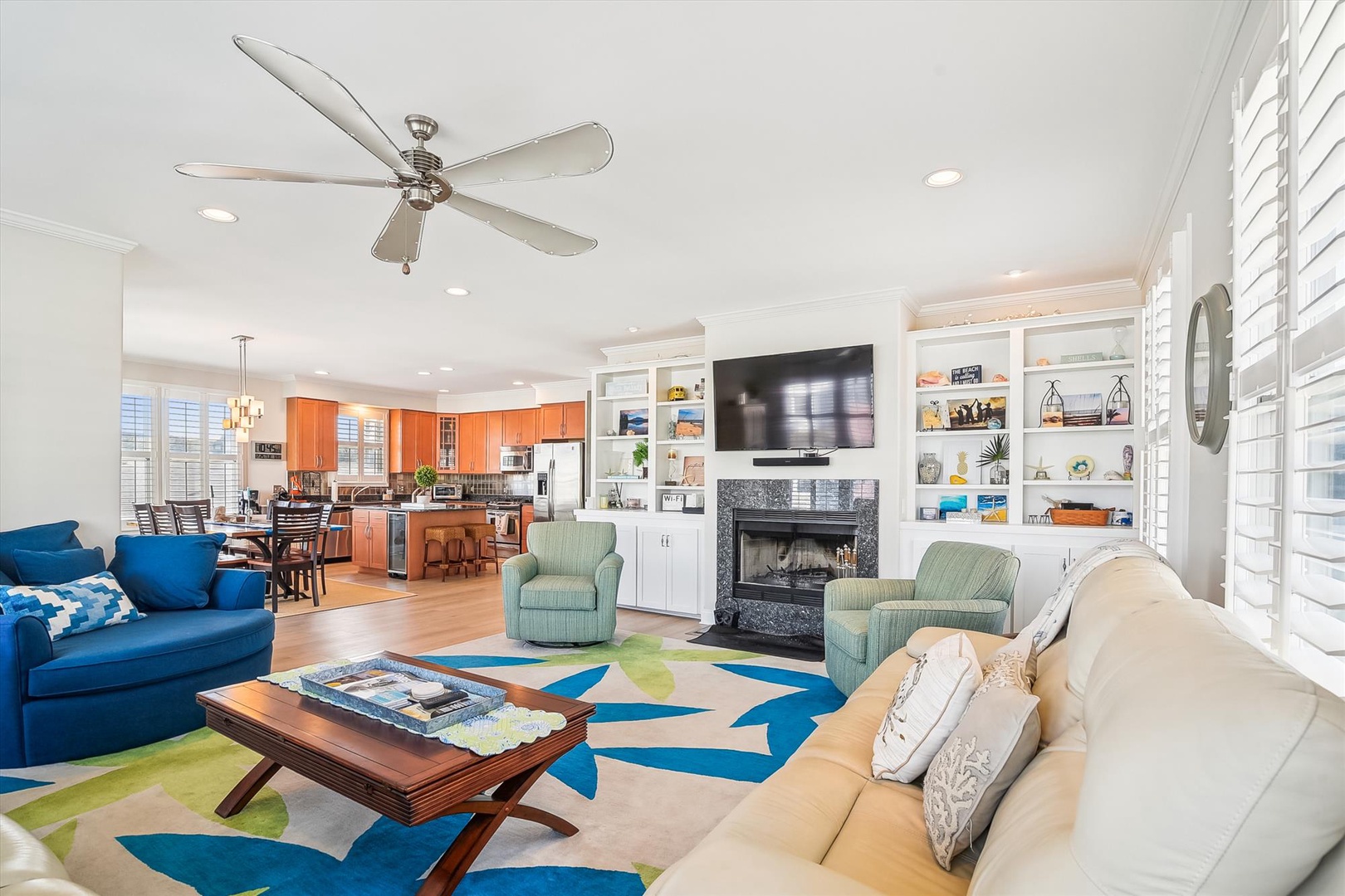 Relax in your spacious open-concept living area with cozy fireplace, modern kitchen, and vibrant décor that creates the perfect home-away-from-home atmosphere.