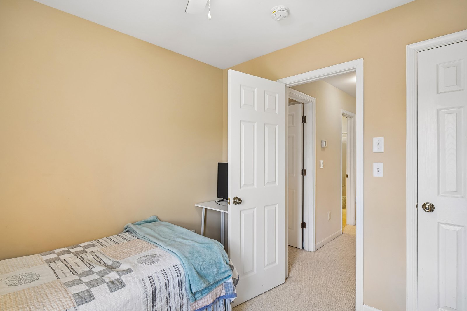 Your cozy bedroom welcomes you with warm tones, soft carpeting, and thoughtfully arranged furnishings—perfect for peaceful rest after a day of exploring.