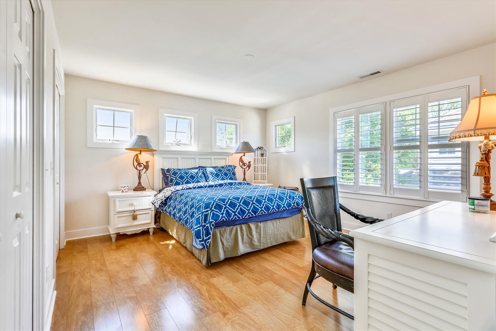 Relax in your serene retreat with a plush bed, abundant natural light, and a quiet workspace—your perfect blend of comfort and function.
