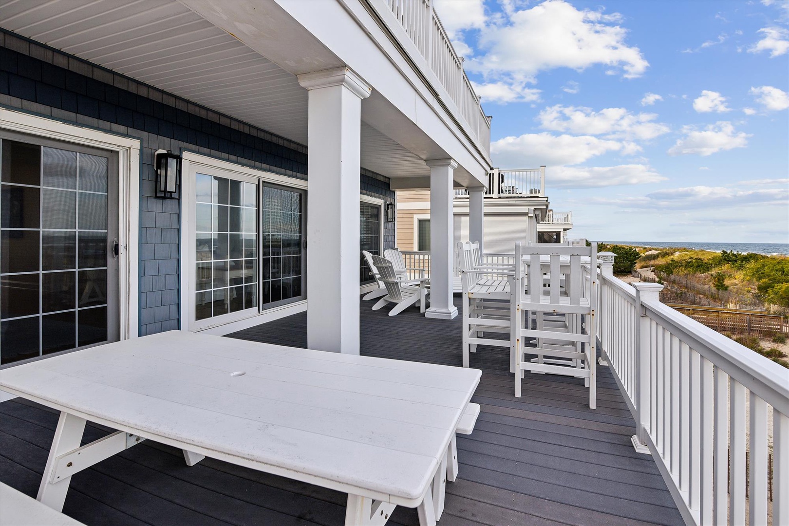 Step onto your private covered deck with coastal views, perfect for morning coffee or evening relaxation. Adirondack chairs invite you to unwind and soak in the serene natural surroundings.
