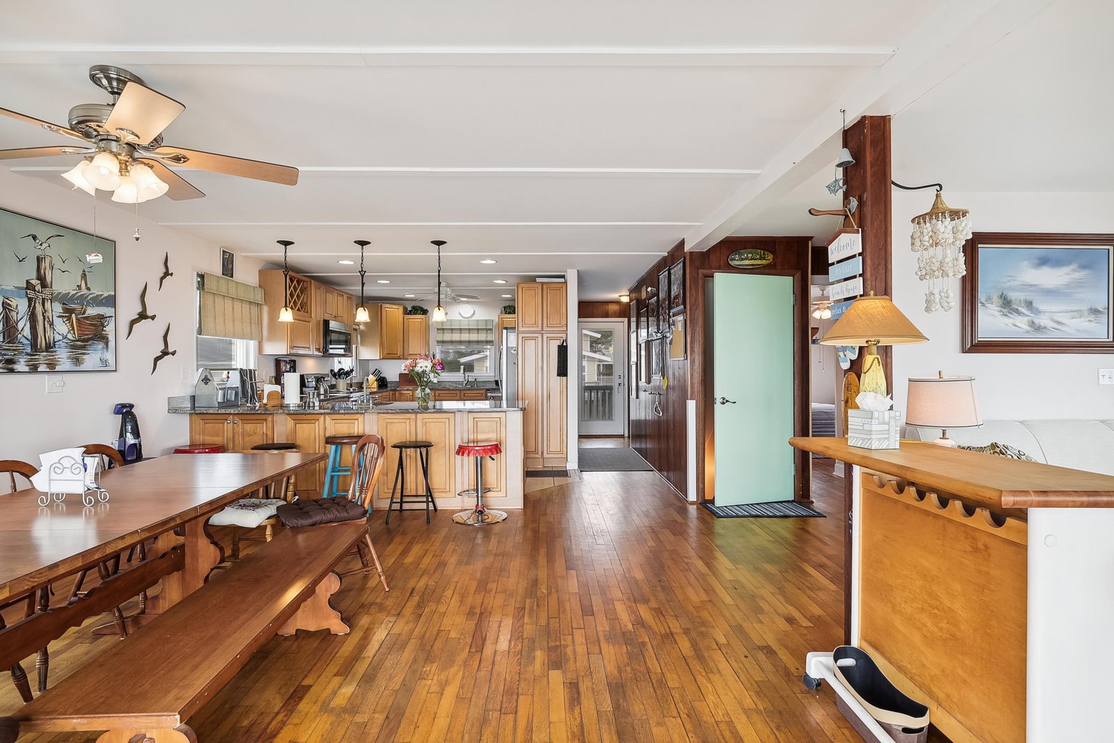 Gather around the rich hardwood floors and blend seamlessly from the dining table to your fully-equipped kitchen. The open layout invites easy conversation while you cook, and the warm wood tones create a cozy, welcoming vibe throughout.