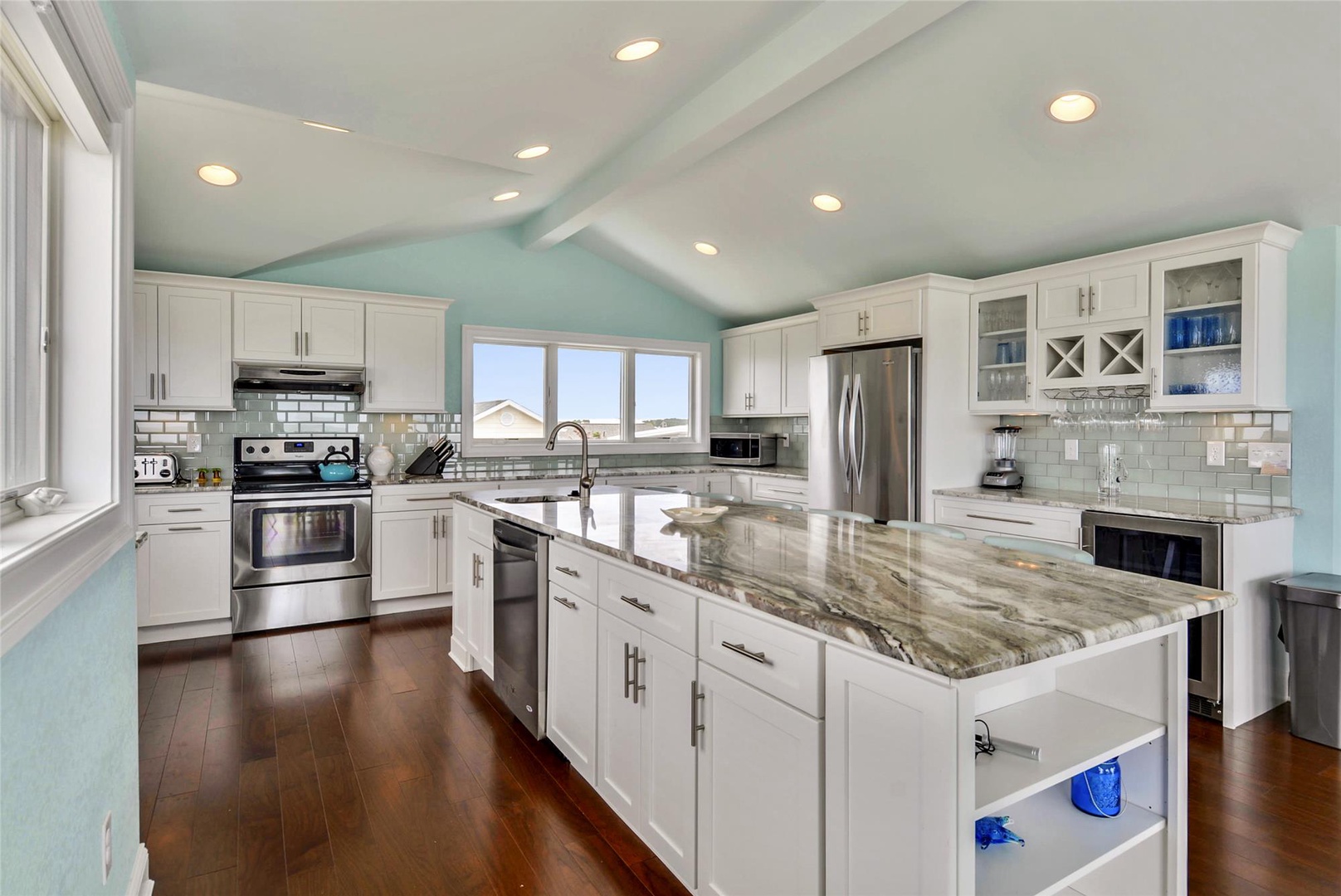 Imagine yourself preparing meals in this stunning gourmet kitchen with gleaming granite counters, stainless appliances, and serene coastal-inspired hues. Perfect for gatherings and culinary adventures.