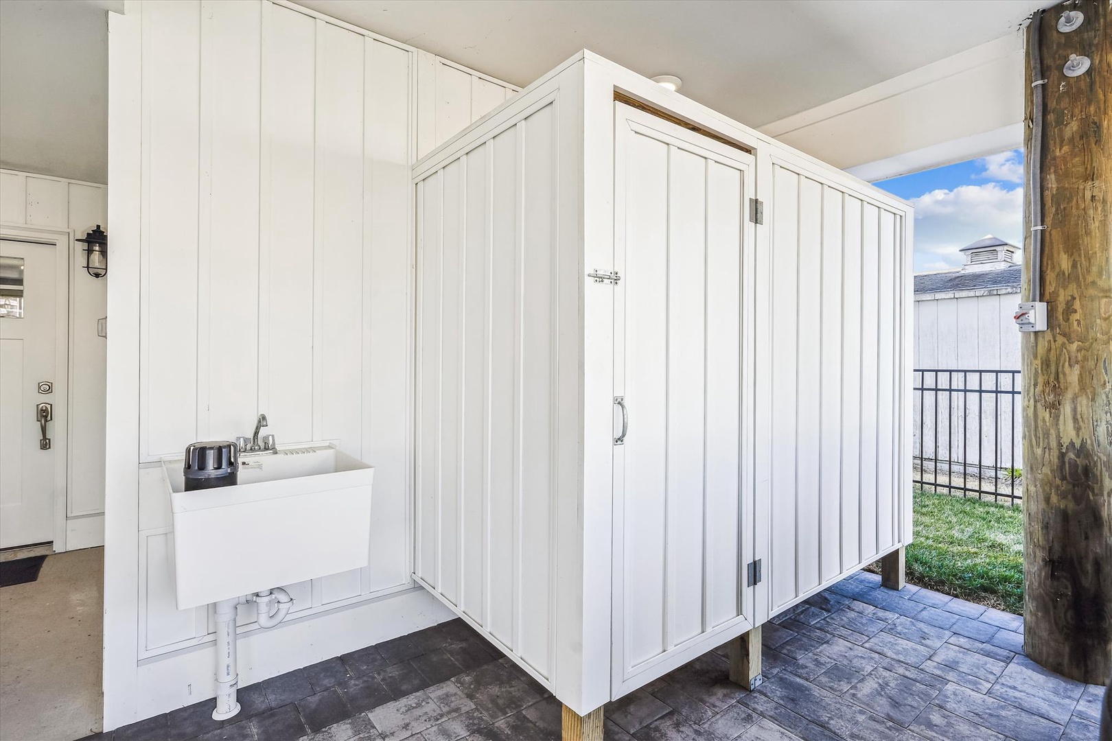 Rinse off salt and sand in your private outdoor shower, surrounded by charming white paneling and mountain views.