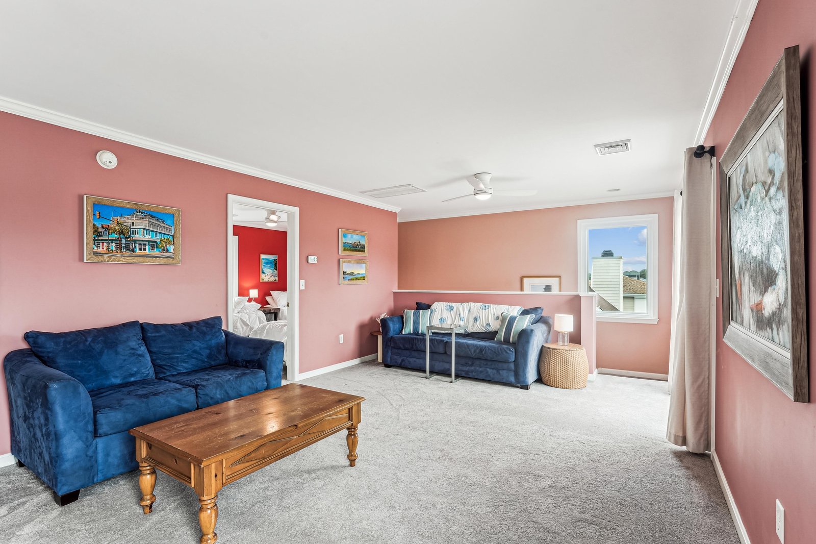 Sink into plush velvet sofas and let the warm coral walls wrap you in comfort. Your spacious retreat invites long conversations and lazy afternoons in style.