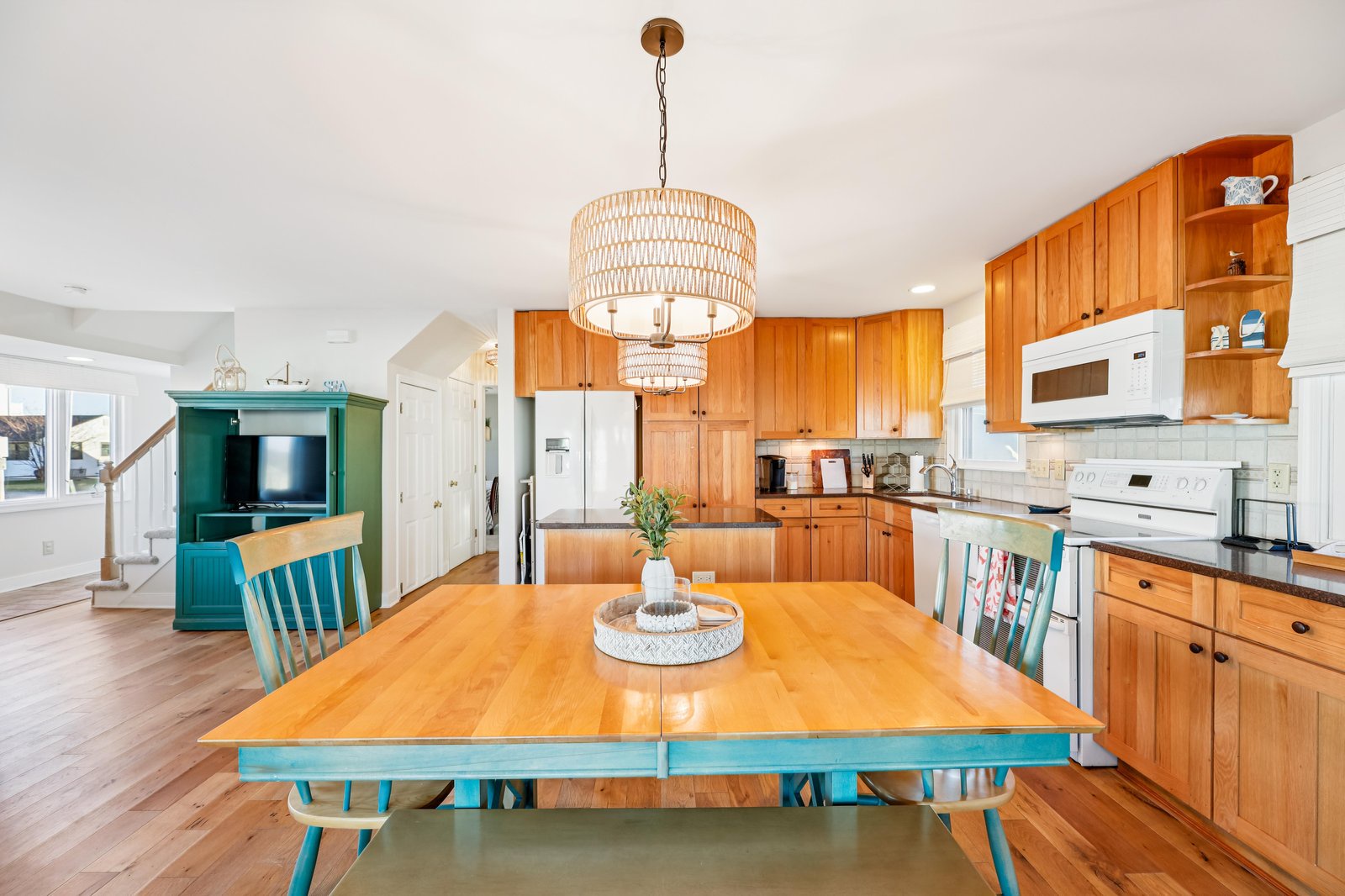 Gather around this warm, inviting kitchen and dining space where your group can share meals together. Natural wood cabinetry and stylish accents create a welcoming atmosphere for cooking and conversation.