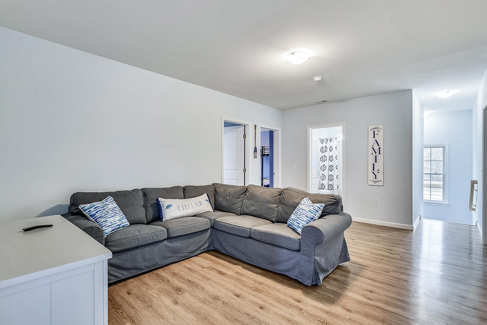 Stretch out on the spacious sectional and feel right at home in this bright, open living space with warm wood floors and plenty of room to unwind.