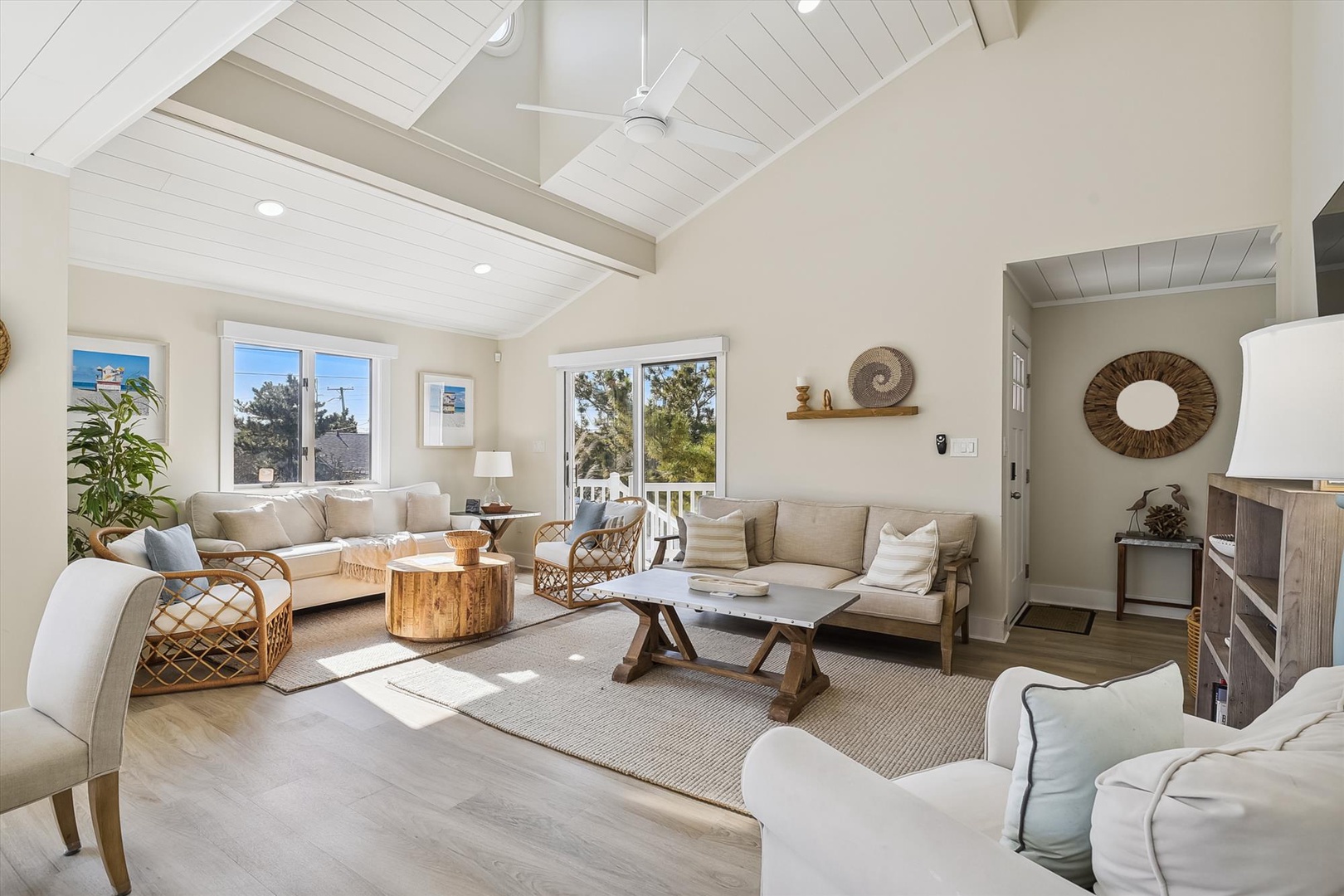 Relax in this sun-filled living room with soaring vaulted ceilings, cozy seating, and coastal-inspired décor that welcomes you home after a day of adventure.