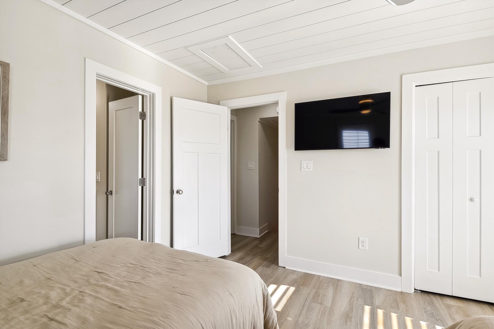 Step into your bright, serene bedroom featuring a cozy bed, flat-screen TV for entertainment, and generous closet space for your belongings—a peaceful retreat for unwinding.