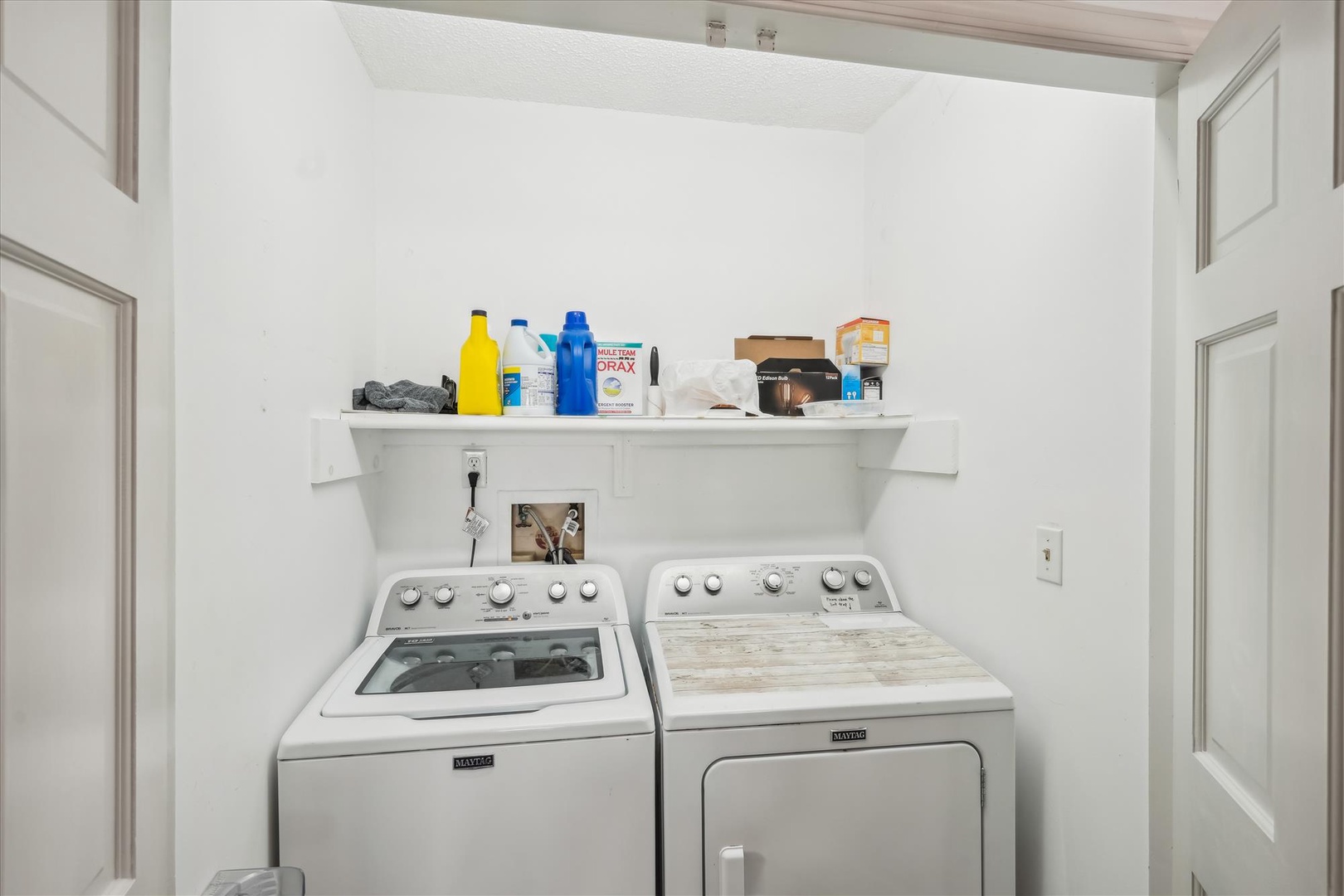 Your laundry essentials are ready for you in this convenient in-unit space, complete with a washing machine, dryer, and shelf storage for all your detergents.