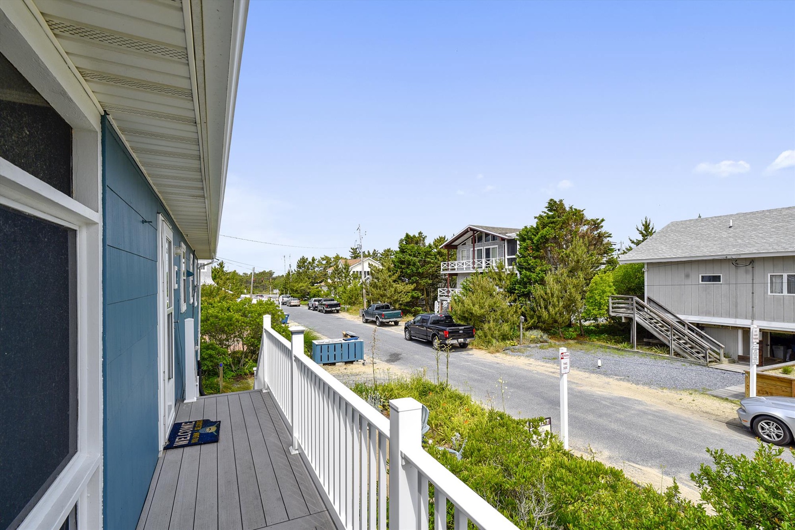 The property is located in a peaceful coastal neighborhood, surrounded by greenery and just steps from local amenities and nearby homes.
