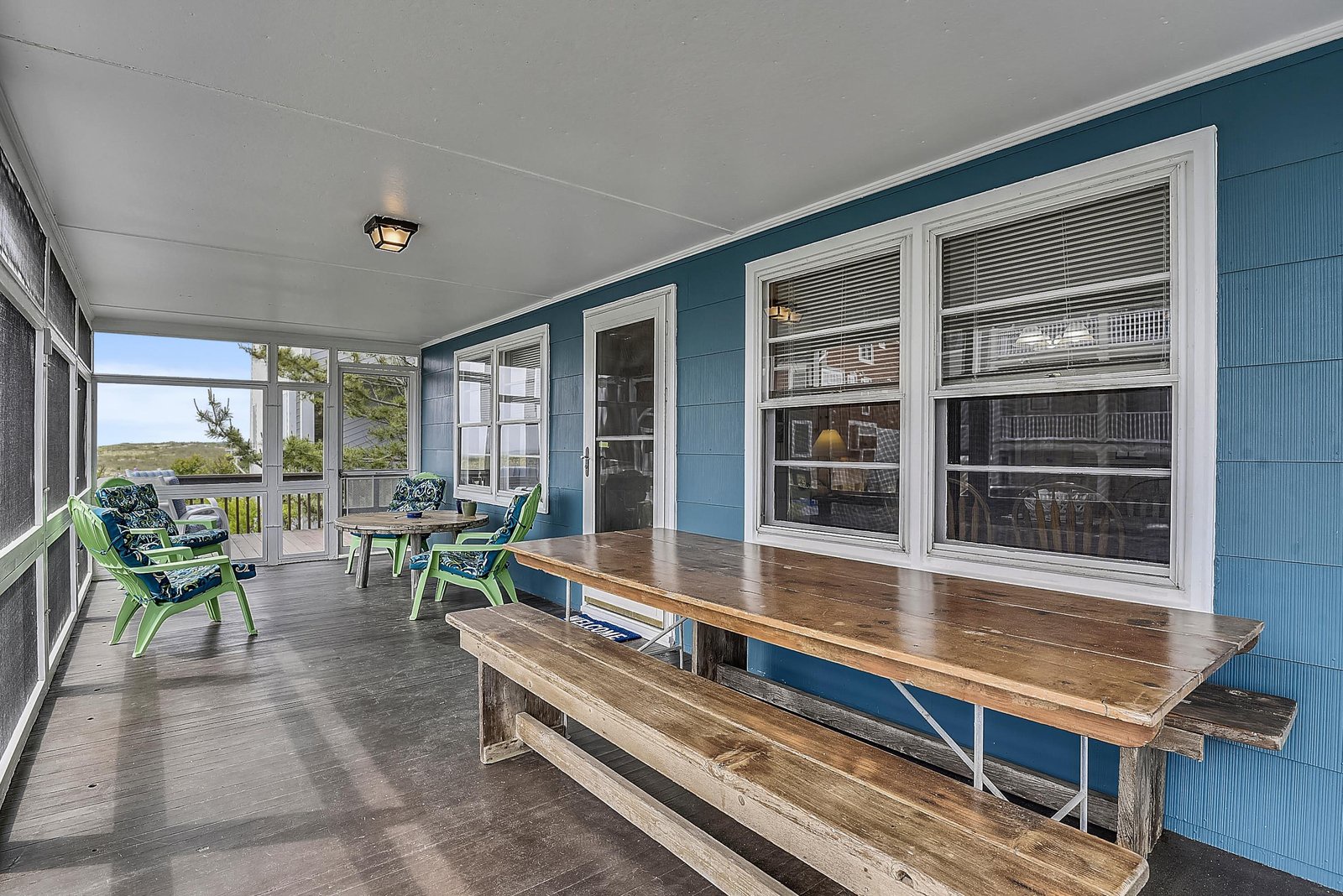 Settle into your screened porch with coastal views, where soft ocean breezes and cheerful seating invite effortless morning coffee or sunset drinks.