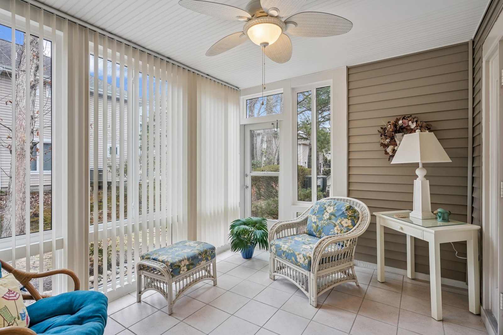 Unwind in your bright sunroom with tropical wicker seating, where morning coffee feels like vacation every day.