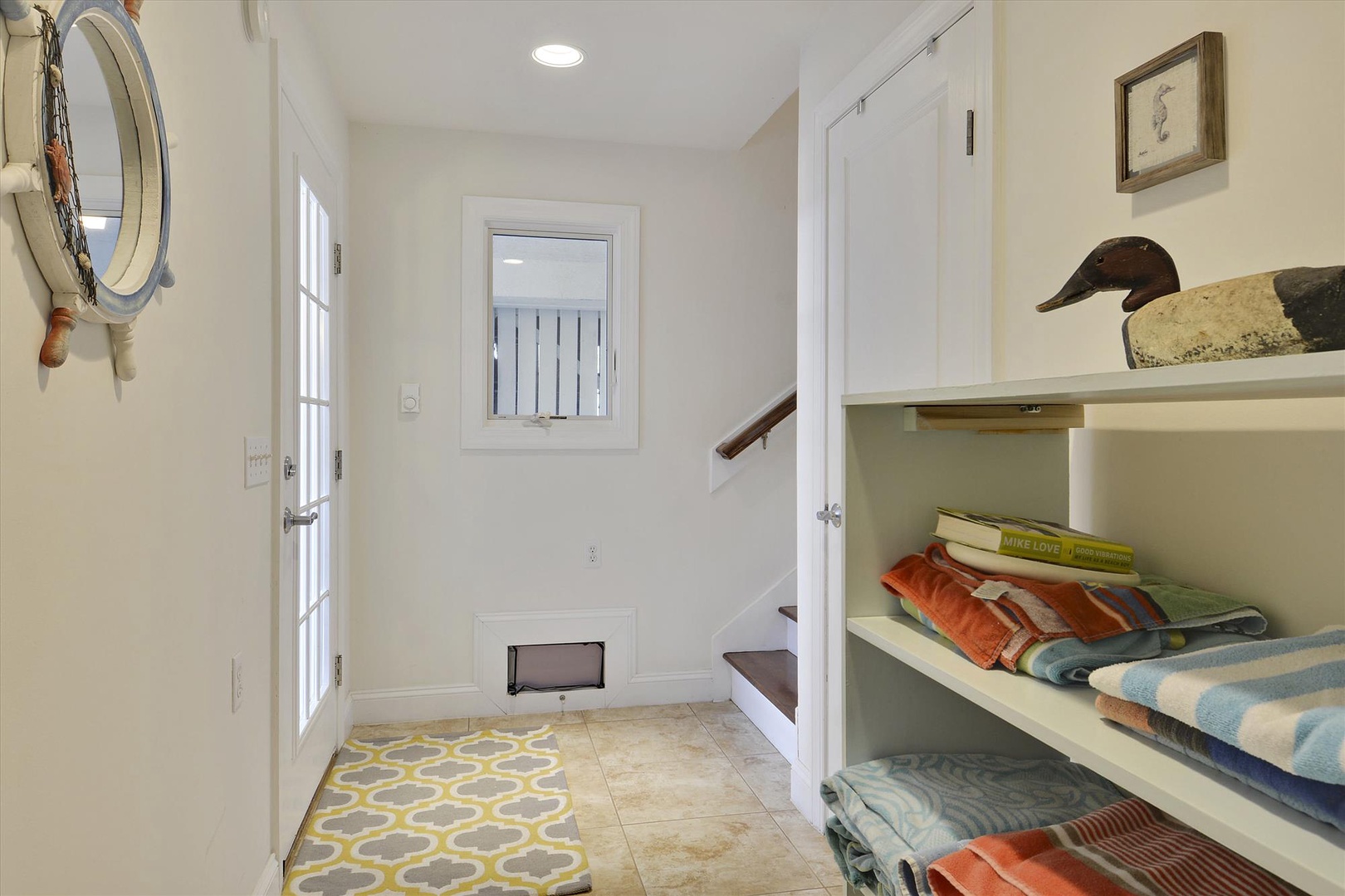Step through the bright entryway and discover thoughtful coastal touches—nautical décor, built-in storage with cozy linens, and a sunny welcome that sets the tone for your relaxing getaway.