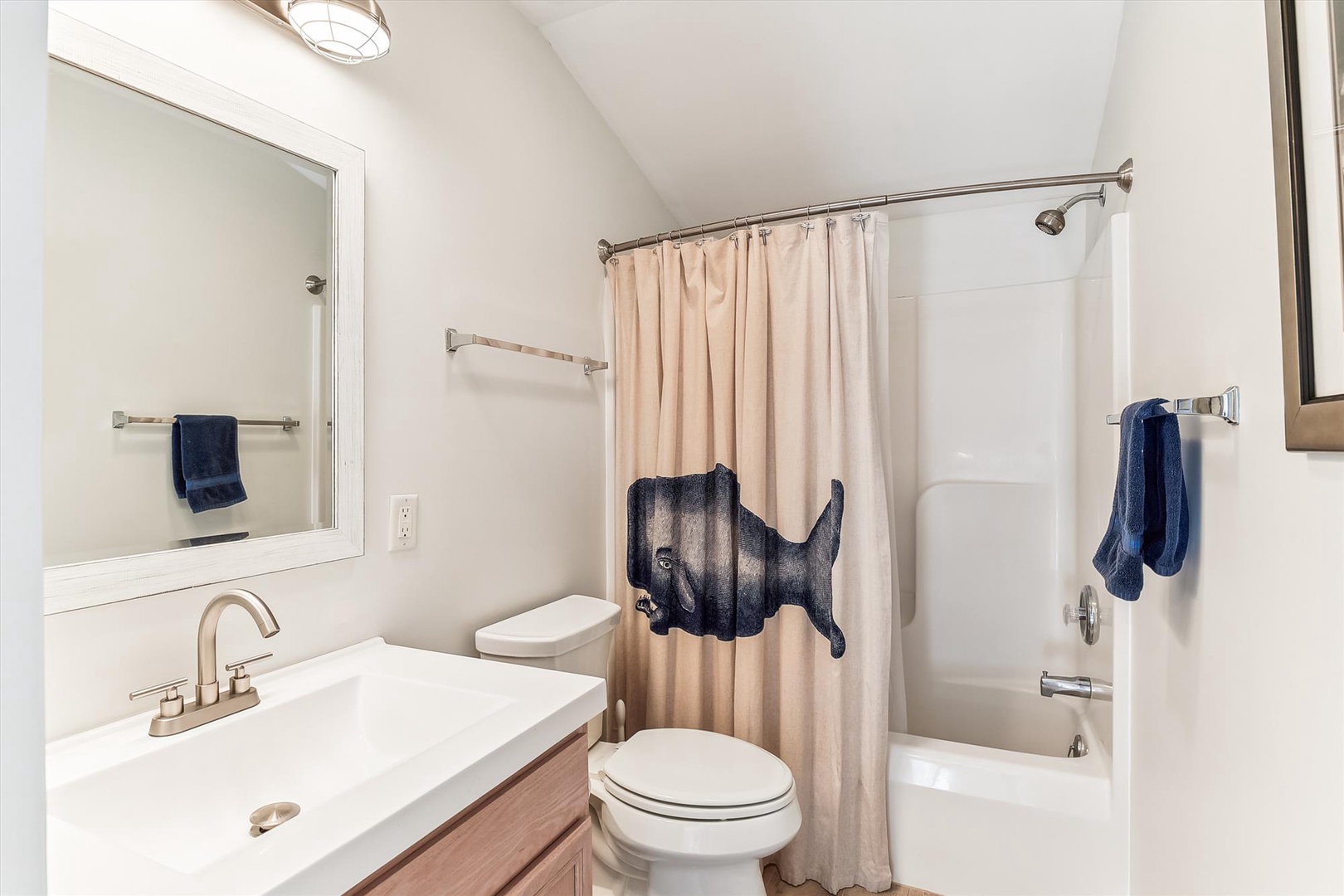Step into your private bathroom with a sleek shower-tub combo, fresh towels, and coastal charm. Clean lines and calming colors make freshening up feel effortless.