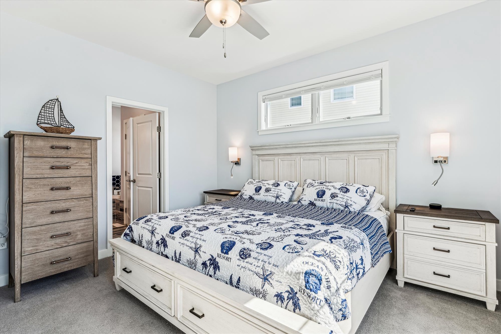 Your coastal-themed bedroom features a comfortable queen bed with charming nautical bedding, perfect for peaceful nights.