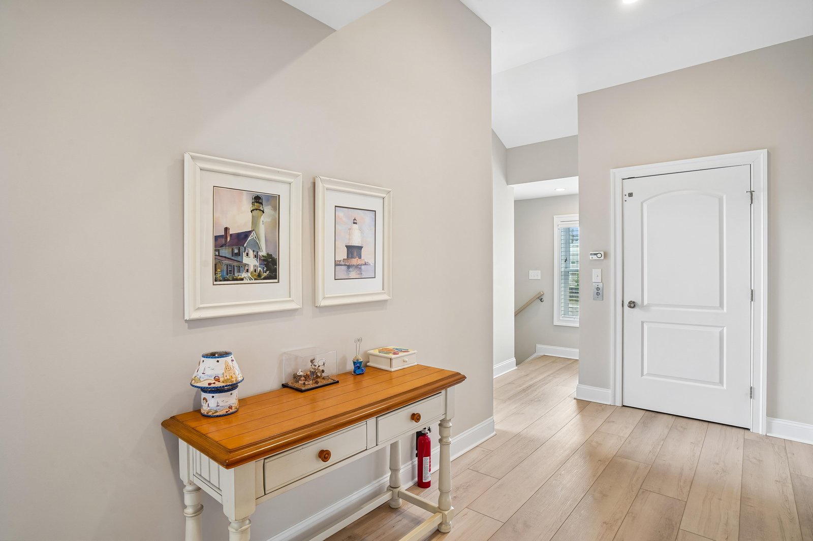 Step through the front door into a warm, welcoming entryway with vaulted ceilings and coastal charm—your serene escape begins here.