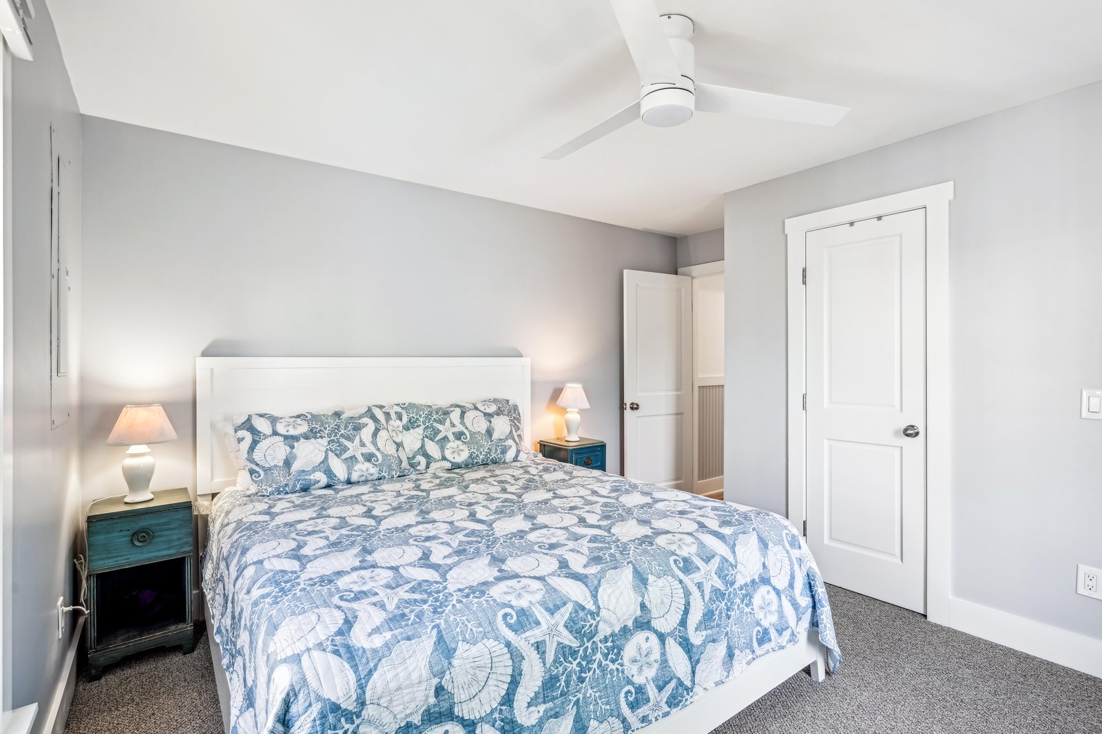 Unwind in your serene bedroom with soothing coastal-inspired bedding, gentle lighting, and a ceiling fan to keep you comfortable all night long.