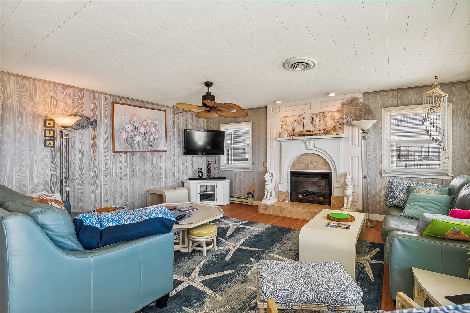 Settle into this bright, cozy living room where cheerful decor, a warm fireplace, and comfy seating invite you to unwind after your day of exploring.