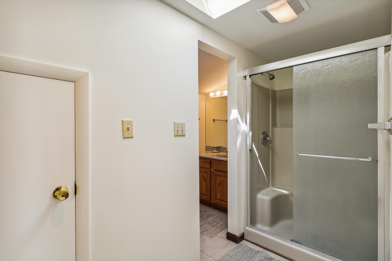 Your private bathroom offers a spacious walk-in shower with modern fixtures, thoughtful lighting, and plenty of storage. Clean, comfortable, and ready for you to unwind.