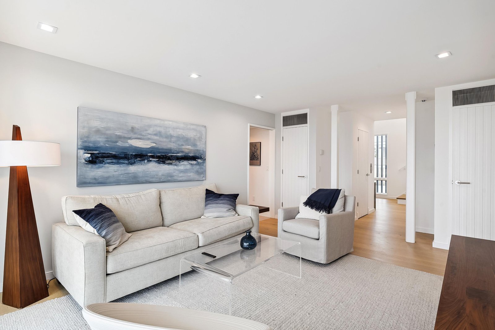 Sink into plush seating in your bright, airy living space where clean lines and calming tones create the perfect retreat after a day exploring.