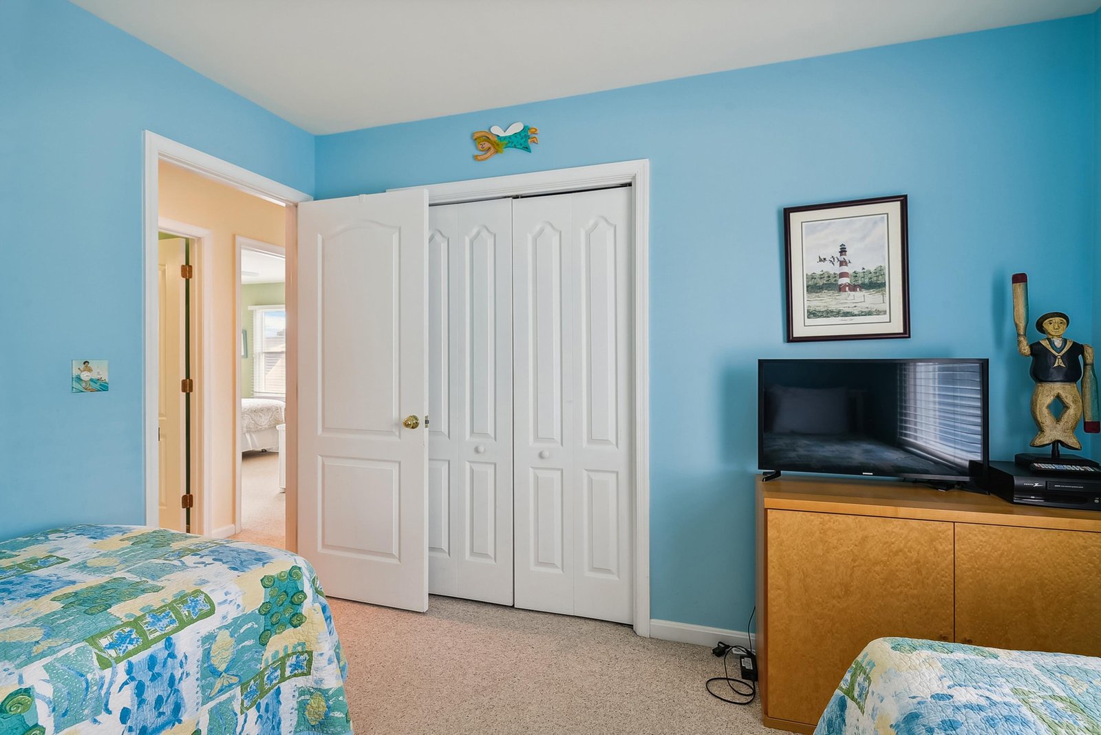 Your cheerful coastal bedroom features twin beds and ample storage, with nautical decor and soothing blue walls to help you unwind after a day at the beach.