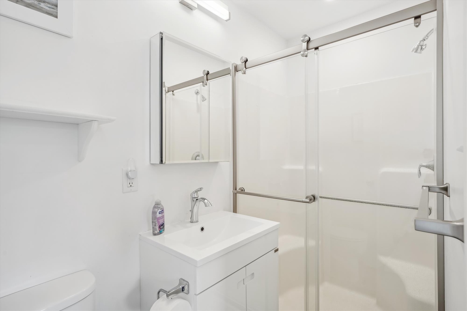 Step into your spa-like bathroom with sleek glass shower doors, modern fixtures, and crisp white finishes that create a serene space to unwind.