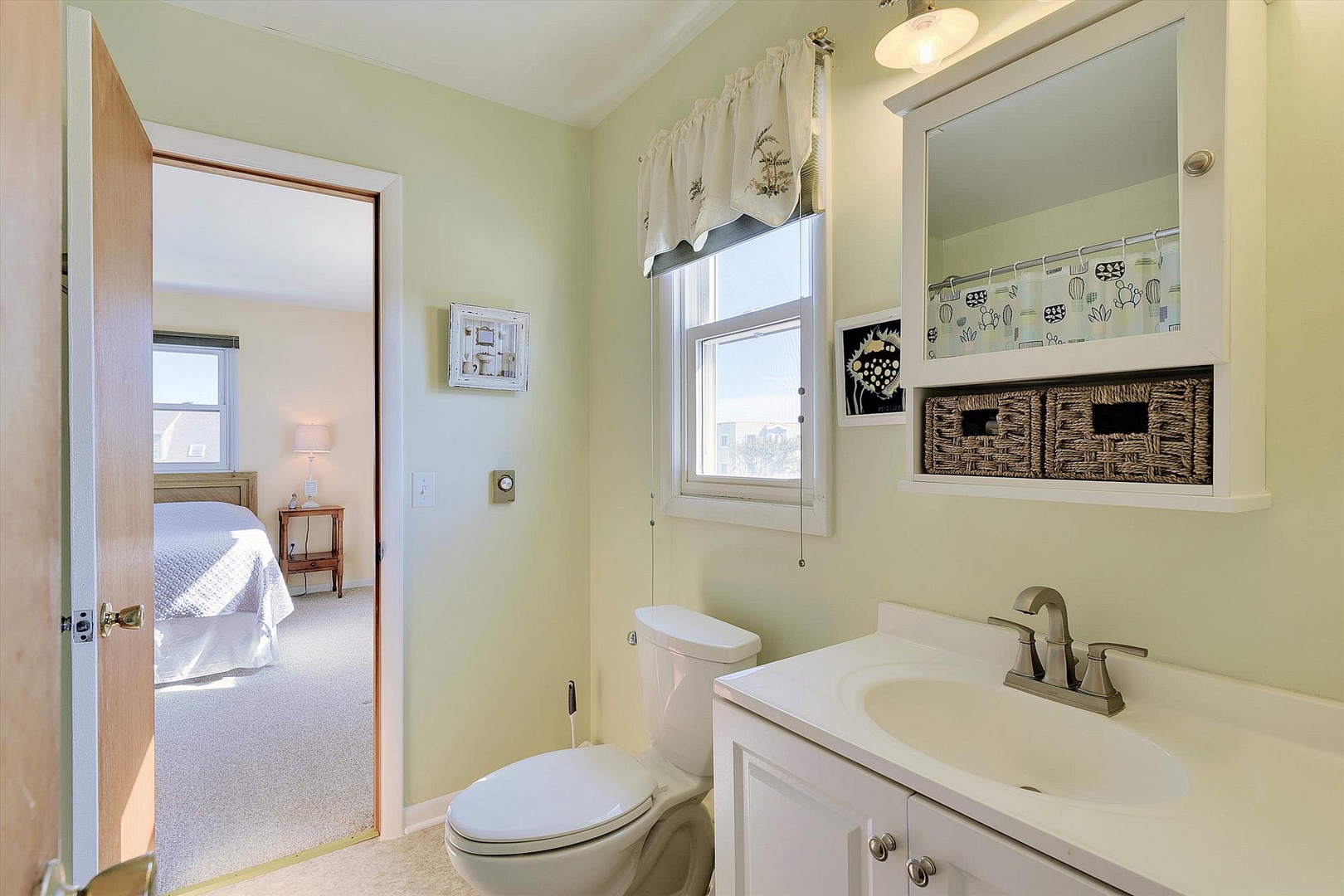 Light-filled bathroom with storage solutions and a serene pale palette, connecting conveniently to your restful bedroom.