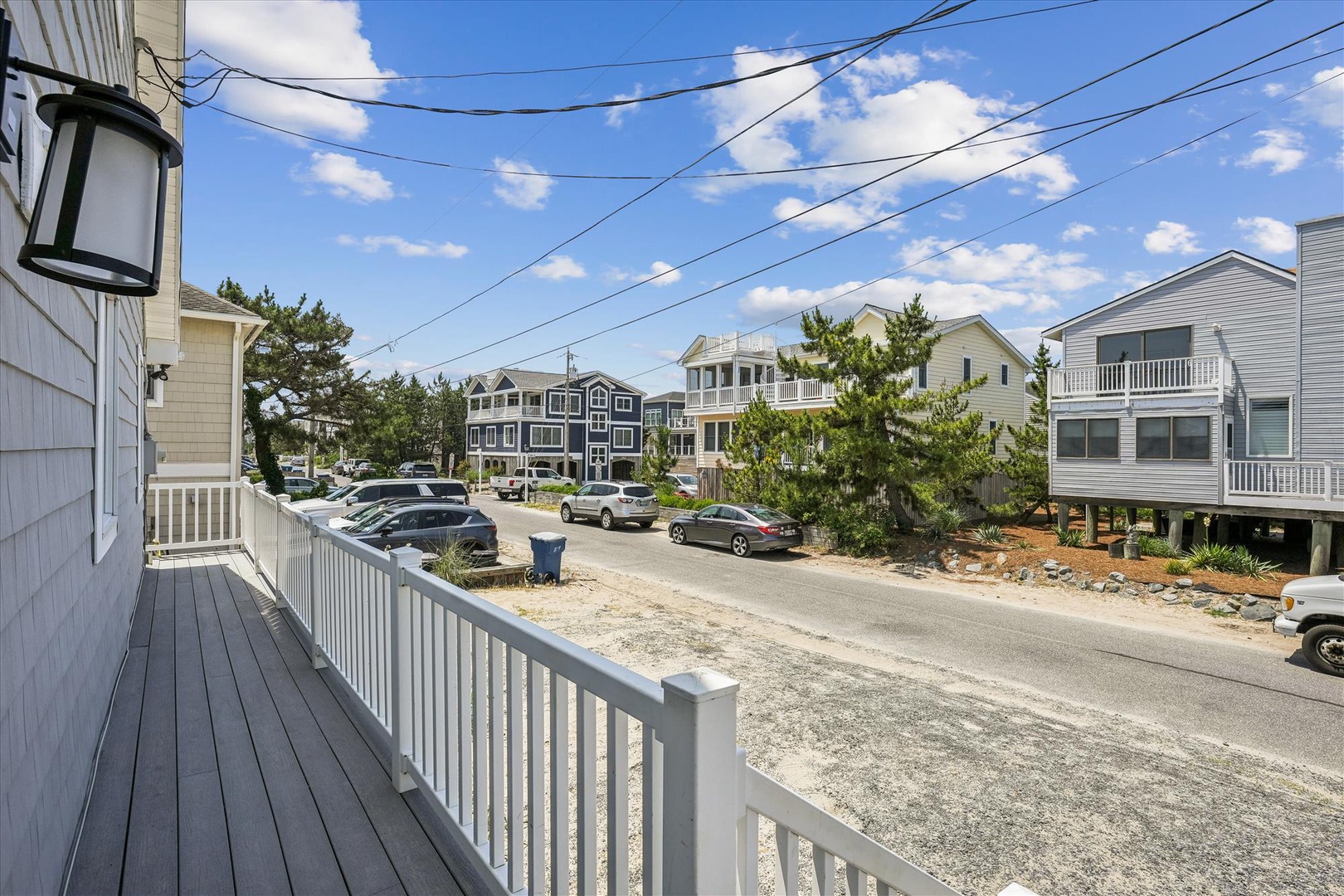 A coastal beach community with nearby vacation homes and convenient street-level parking just moments from the shore.