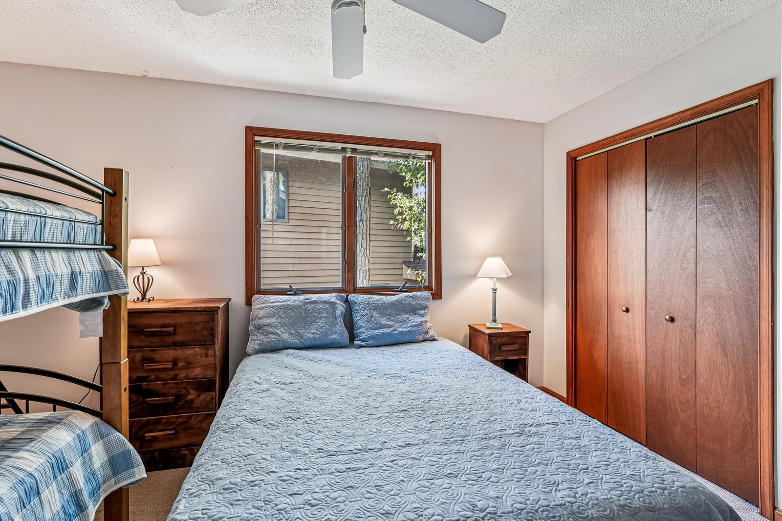 Your cozy bedroom features soft lighting, warm wood furnishings, and a plush bed that invites you to unwind after a day of exploring.