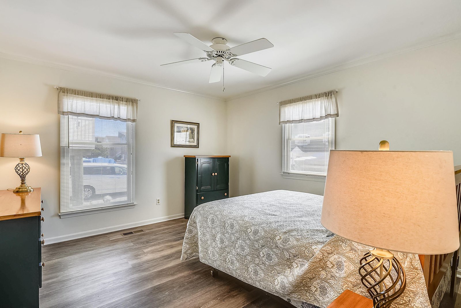 Rest easy in your peaceful bedroom, where natural light streams through dual windows and a gentle ceiling fan keeps you comfortable all night long.