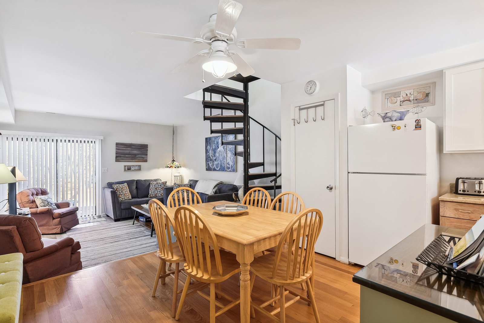 An open-concept space where you can cook, gather for meals, and relax—all under vaulted ceilings with a spiral staircase adding a unique touch to your stay.