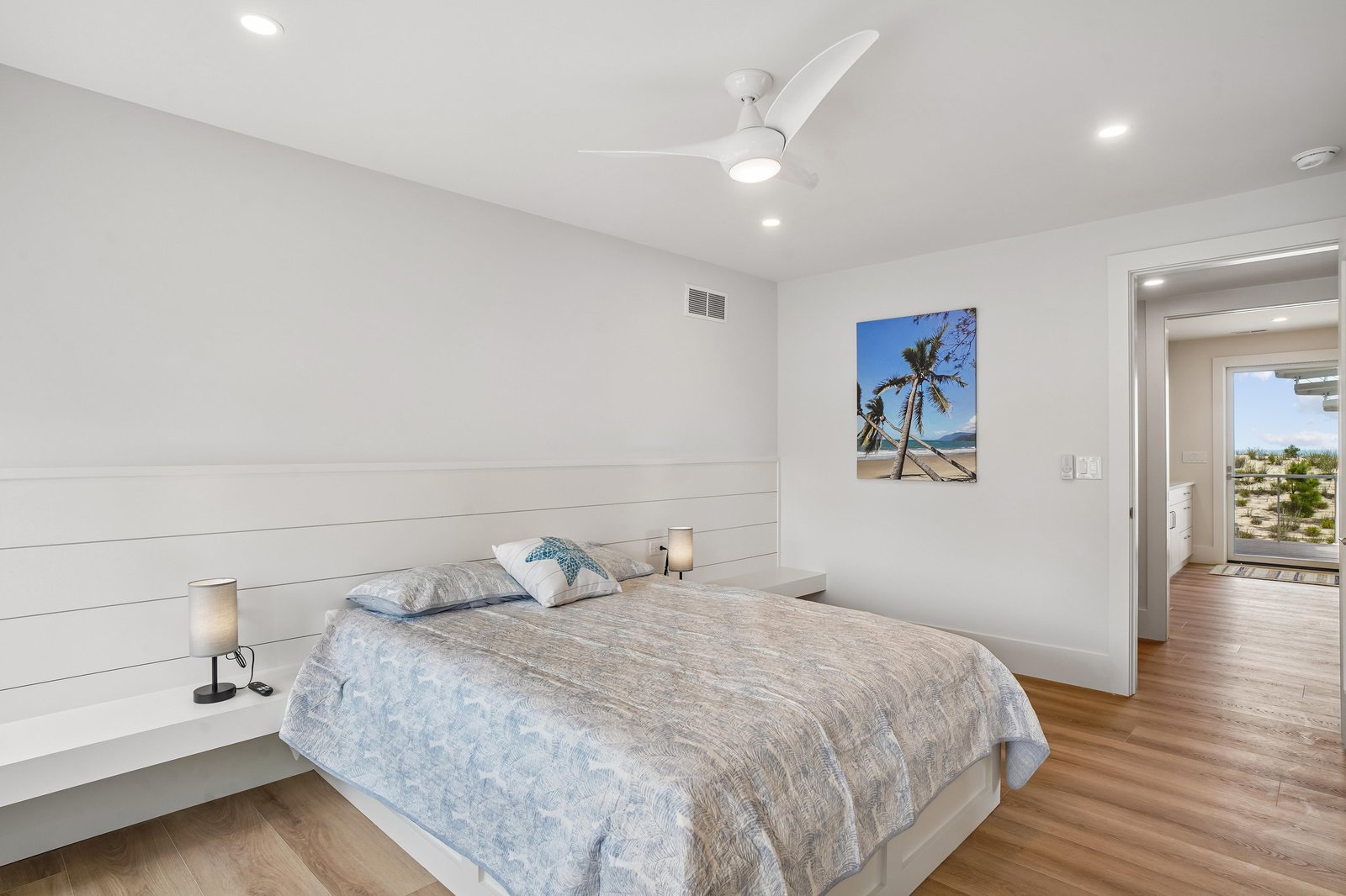 A crisp coastal retreat where soft coastal hues and warm wood floors create your peaceful sanctuary. Rest easy beneath a gentle ceiling fan and wake refreshed to explore the day ahead.