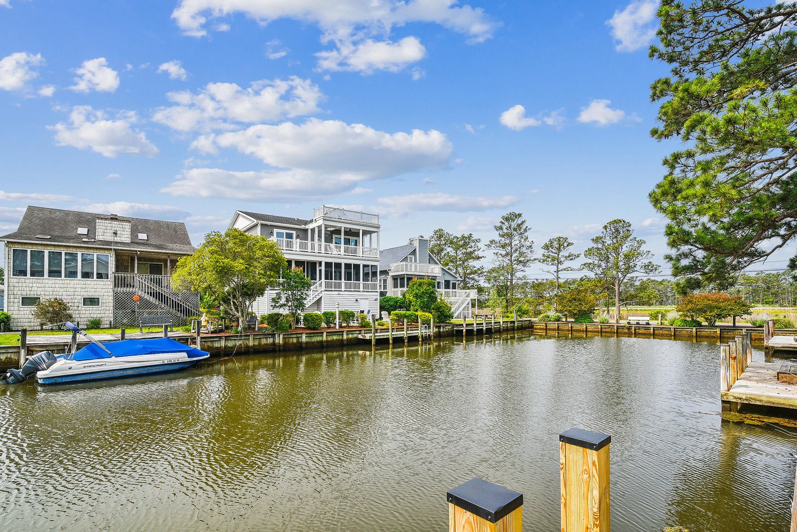 This waterfront property sits on a serene canal with private dock access and lush greenery all around. Surrounded by charming coastal homes and easy boat access, the setting offers peaceful waterside living and a perfect escape.