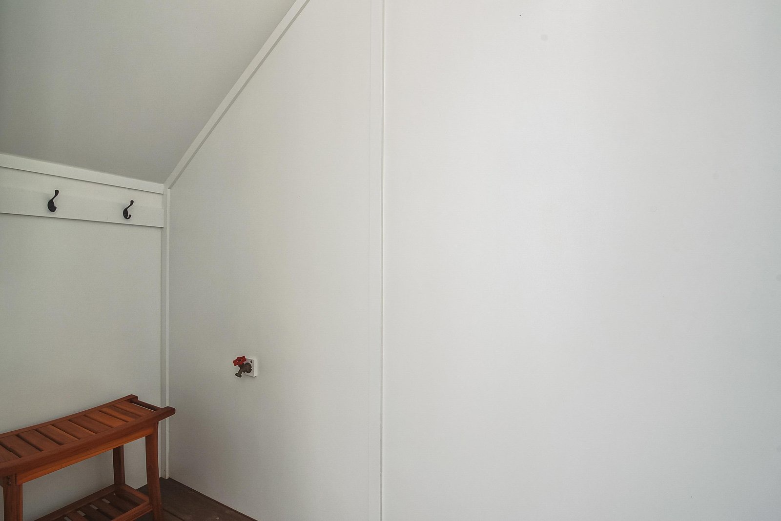 Hang your coat on the wall hooks and settle in—this clean, minimalist space is yours to relax in during your stay.