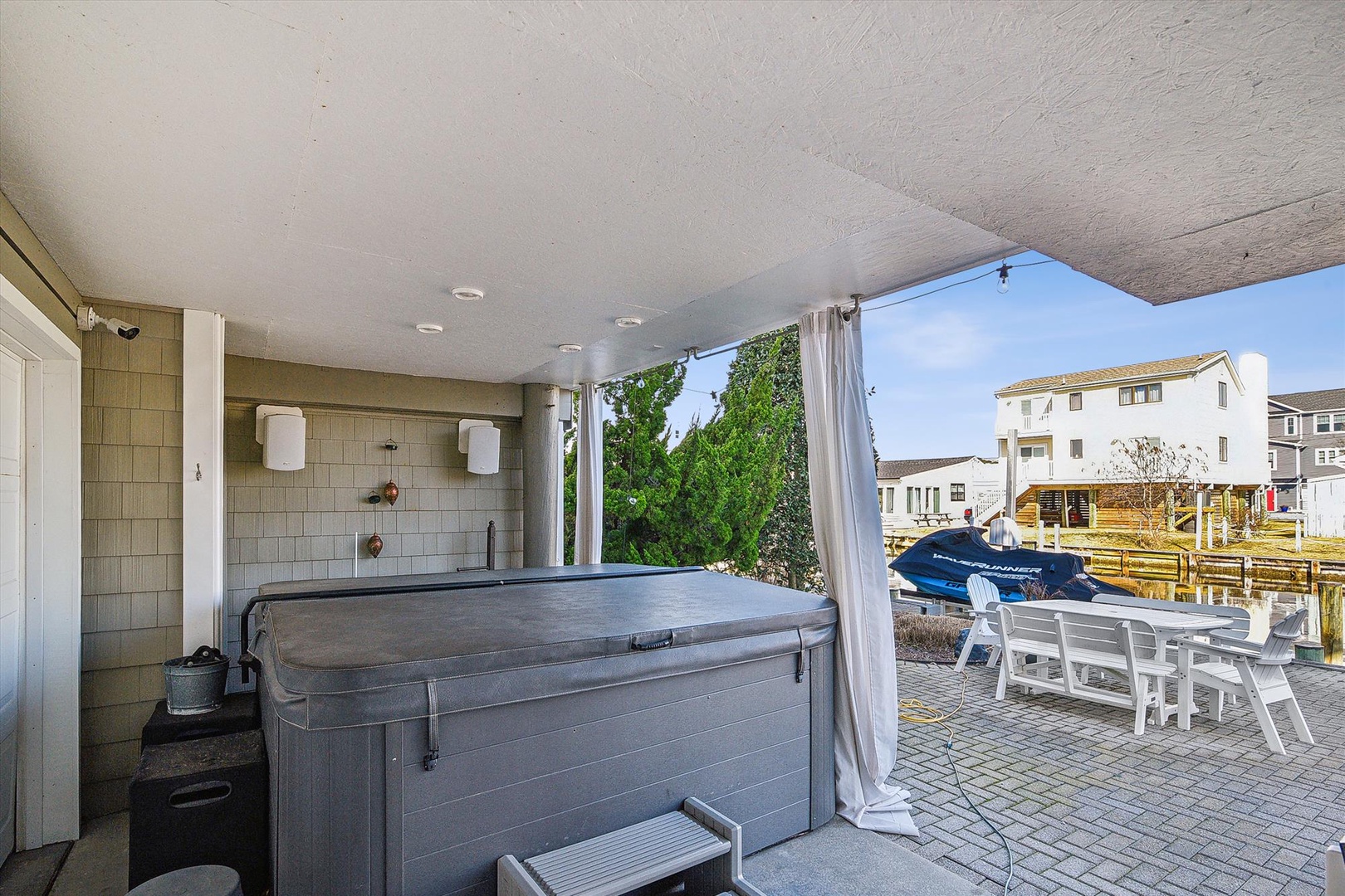 Unwind in your private hot tub while soaking up waterfront views and gentle breezes from this covered terrace.