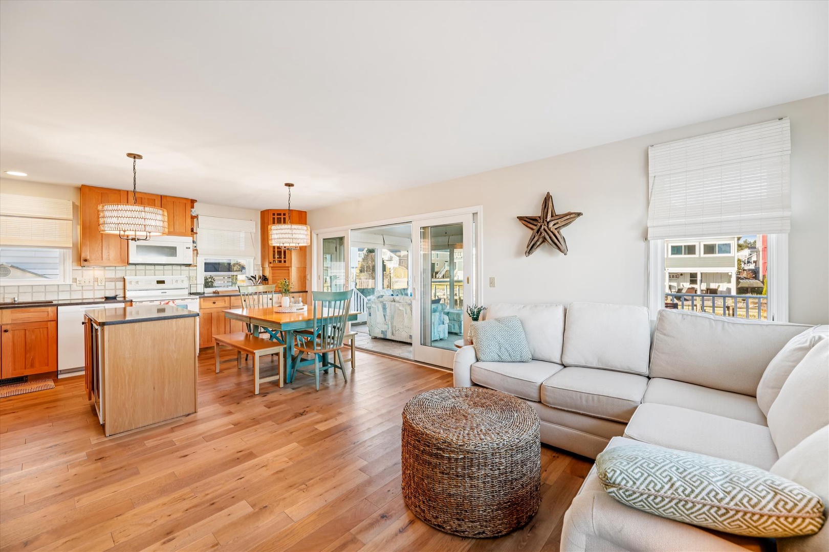 Relax in your bright open-concept living space with coastal touches, where the kitchen flows seamlessly into your comfortable lounge area.