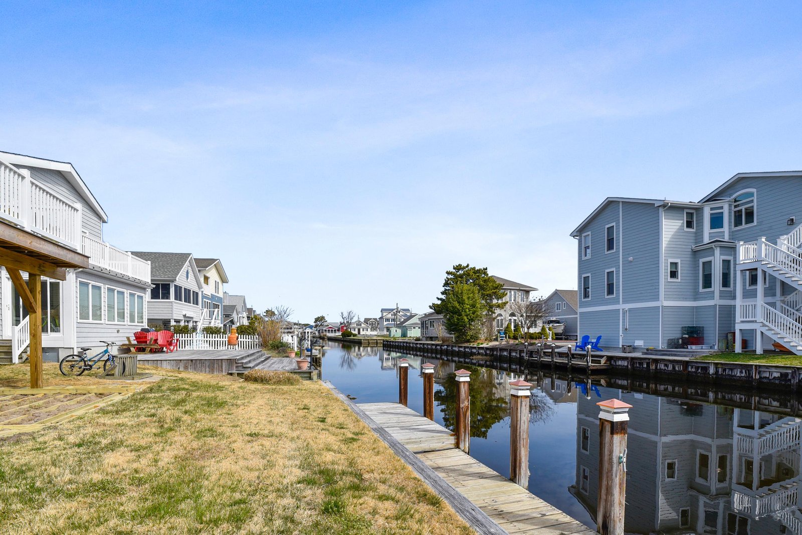 Waterfront canal-front property with private dock access, surrounded by neighboring vacation homes in a peaceful coastal community.