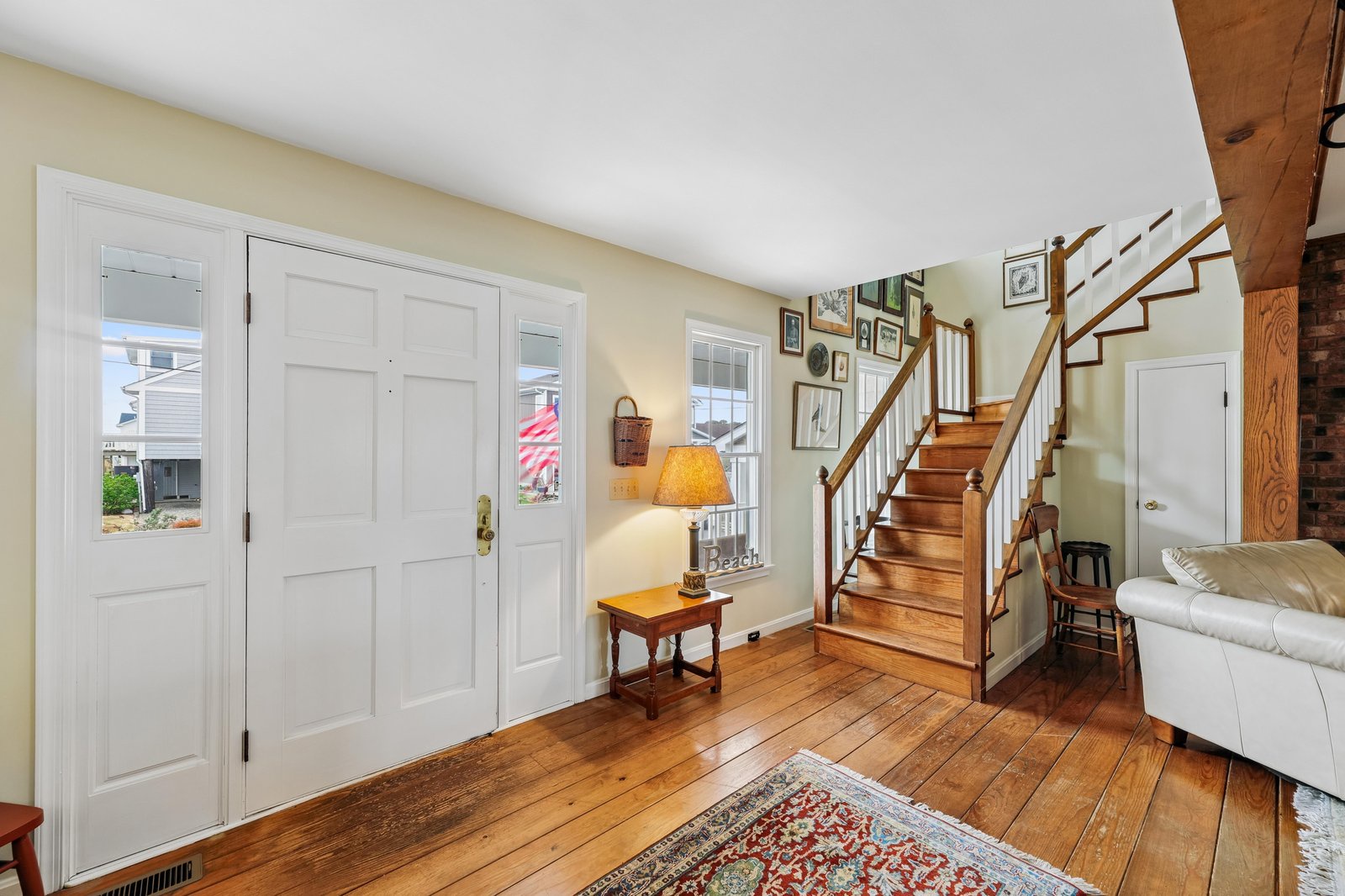 Step into a welcoming entryway with gleaming hardwood floors and natural light. The warm ambiance and easy layout make you feel right at home the moment you arrive.