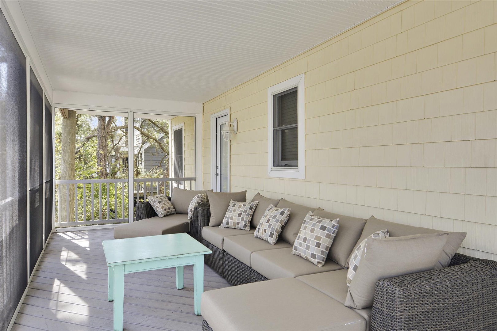 Unwind on your private screened porch with plush seating and peaceful tree views - perfect for morning coffee or evening relaxation.