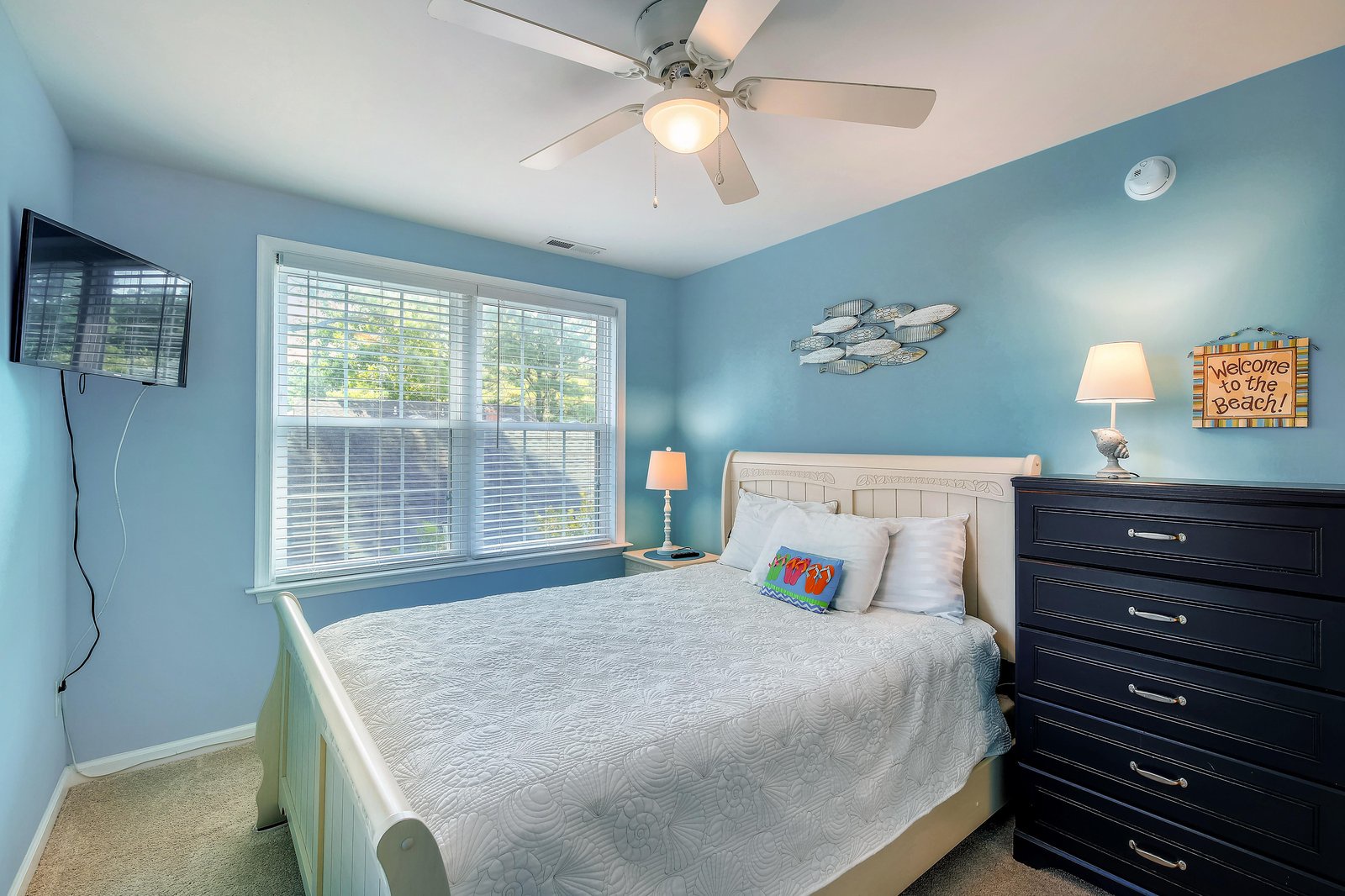 Drift off under coastal-blue skies in your serene beach-themed bedroom, where soft lighting and fresh breezes welcome you after a day of adventure.