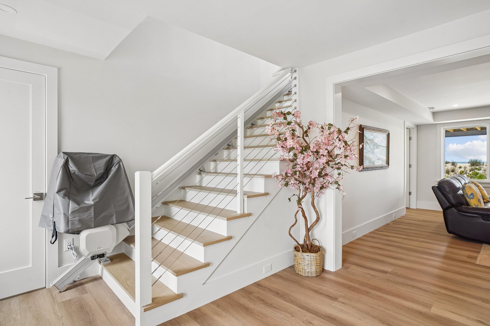 Your home away from home features bright, open spaces with warm wood floors and a welcoming touch of coastal charm—like the cheerful cherry blossoms greeting you as you arrive.