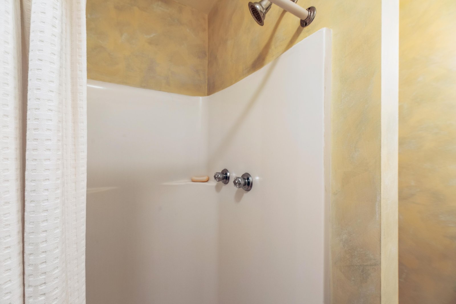 Clean, well-appointed shower with warm tones awaits you after a day of adventure.