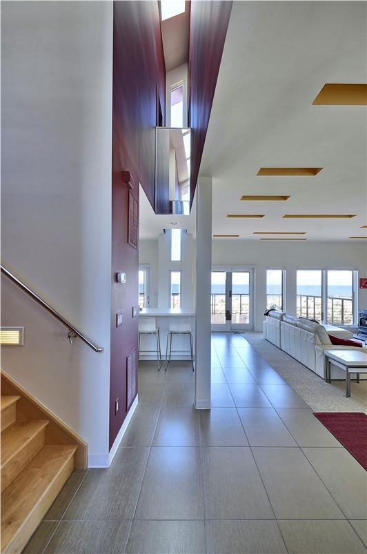 Soaring ceilings and walls of windows flood your space with natural light, creating an airy, open atmosphere where modern design meets effortless comfort.