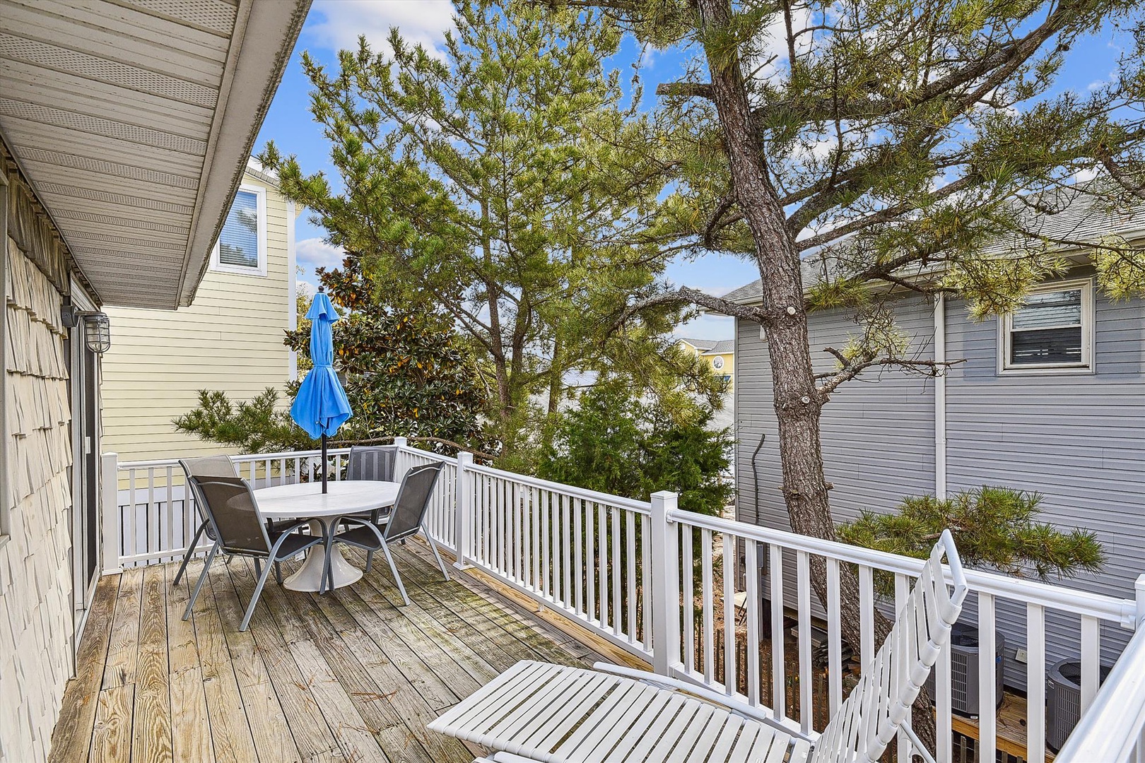 Step onto your private deck with outdoor dining, shaded by mature pines. Perfect for morning coffee or alfresco meals in peaceful surroundings.